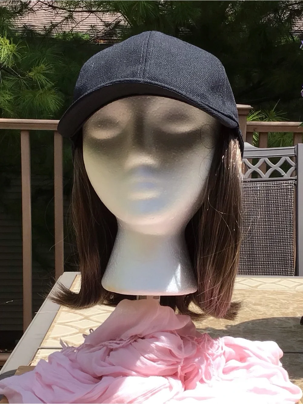 Black baseball cap with brown/blonde highlights attached wig